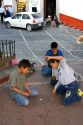 Mexican boys playing a game of pogs in the plaza at Taxco in the State of Guerrero, Mexico.
