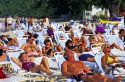 People sunbathe at the beach on Grand Cayman Island.