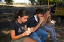 People eat chorizo sandwiches along the Rio de la Plata in Buenos Aires, Argentina.