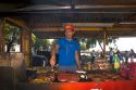 Street vendor grilling meat along the Rio de la Plata in Buenos Aires, Argentina.