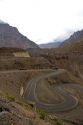 Vehicles travel on switchback roads in the Andes Mountain Range, Chile.