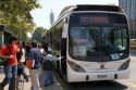 An articulated bus is part of the Transantiago public transport system picks up passengers at a bus stop in Santiago, Chile.