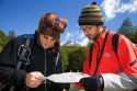 Hikers from Israel look at a map in the Tierra del Fuego National Park, Argentina. MR