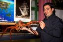 Waiter holding a king crab at a seafood restaurant at Ushuaia, Argentina.