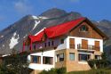 Chalet style house below the Martial mountain range at Ushuaia, Tierra del Fuego, Argentina.