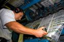 Pressman fin tunes newspaper being printed on a rotary printing press for the Houston Chronicle in Houston, Texas.