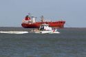 Oil tanker and U.S. Coast Guard patrol boat in Galveston Bay, Texas.