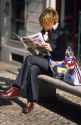 Italian woman reading a newspaper in Torino, Italy.