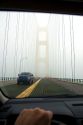 View from the inside of a car crossing the Mackinac Bridge on a foggy day in Michigan.