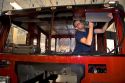 Worker installing accessories into a newly manufactured fire truck chassis at Spartan Motors in Charlotte, Michigan.