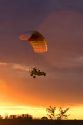 Powered parachute flying at sunset in Eaton County, Michigan.