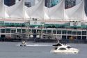 Seaplane and boat in front of Canada Place in Vancouver, British Columbia, Canada.