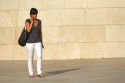 Woman talking on a cell phone in front of the Guggenheim Museum in the city of Bilbao, Biscay, Basque Country, northern Spain.