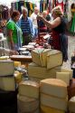 Vendor selling cheese and sausage at an outdoor market in the town of Cangas de Onis, Asturias, northern Spain.