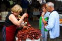 Vendor selling sausage at an outdoor market in the town on Cangas de Onis, Asturias, northern Spain.