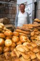 Vendor selling bread and baked goods at an outdoor market in the town of Cangas de Onis, Asturias, northern Spain.