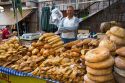 Vendor selling bread and baked goods at an outdoor market in the town of Cangas de Onis, Asturias, northern Spain.