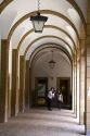 People stand under and arched portico on the campus of the University of Deusto in the city of Bilbao, Biscay, northern Spain.