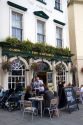 People dine outdoors at The Huntsman pub in Bath, Somerset, England.