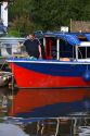 Man cooking on a narrowboat moored in the River Avon at Stratford-upon-Avon, Warwickshire, England.