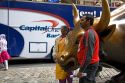 Tourists having their photo taken with the Wall Street Bull in Bowling Green park near Wall Street, New York City, New York, USA.