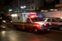 Ambulance in motion at night in Manhattan, New York City, New York, USA.