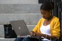African American female student studying with a laptop on the campus of Harvard University in Cambridge, Greater Boston, Massachusetts, USA. MR