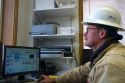 Operator using computers to monitor the system of a geothermal power plant in Malta, Idaho, USA. MR