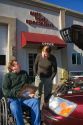 Handicapped insurance claims adjuster with customer assessing the damage of her automobile in Boise, Idaho, USA. MR