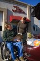Handicapped insurance claims adjuster with customer assessing the damage of her automobile in Boise, Idaho, USA. MR