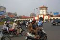 Vietnamese people ride motorbikes in front of the Ben Thanh Market in Ho Chi Minh City, Vietnam.