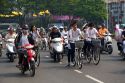 Vietnamese people ride bicycles and motorbikes in Ho Chi Minh City, Vietnam.