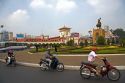 Vietnamese people ride motorbikes in front of the Ben Thanh Market in Ho Chi Minh City, Vietnam.