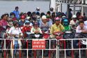 Passengers on motorbikes ride a ferry across the Saigon River in Ho Chi Minh City, Vietnam.
