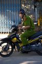 Vietnamese soldier riding a motorbike in Hoi An, Vietnam.