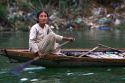 Vietnamese woman paddling a boat on the Perfume River at Hue, Vietnam.