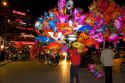 Street vendors selling colorful balloons for Tet in Hanoi, Vietnam.