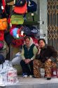 Vendors selling bags and luggage on the street in Hanoi, Vietnam.