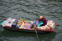 Vendors in boats selling snack food to tourists in Ha Long Bay, Vietnam.