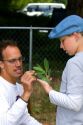 Student and teacher in a summer gardening class identify a weed from a residential garden in Boise, Idaho, USA.