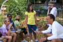 Students and teacher in a summer gardening class identify weeds from a residential garden in Boise, Idaho, USA.