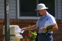 Postman delivering mail to a residence in Boise, Idaho, USA.