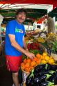 French vendor stocking produce at an outdoor market in Sanary sur Mer, Southern France.