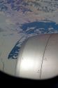 Aerial view of the glaciers and icebergs of Greenland from the window of an Airbus 330 passenger jet airliner.