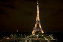 The Eiffel Tower lit up at night located on the Champ de Mars in Paris, France.