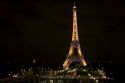 The Eiffel Tower lit up at night located on the Champ de Mars in Paris, France.