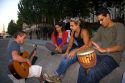 Young parisiens play music along the River Seine in Paris, France.