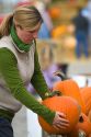Woman shopping for pumpkins at a farmers market in Fruitland, Idaho. MR