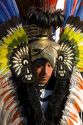 Native Aztec people dance wearing tradional costume in the Zocalo of Mexico City, Mexico.