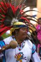 Native Aztec people dance wearing tradional costume in the Zocalo of Mexico City, Mexico.